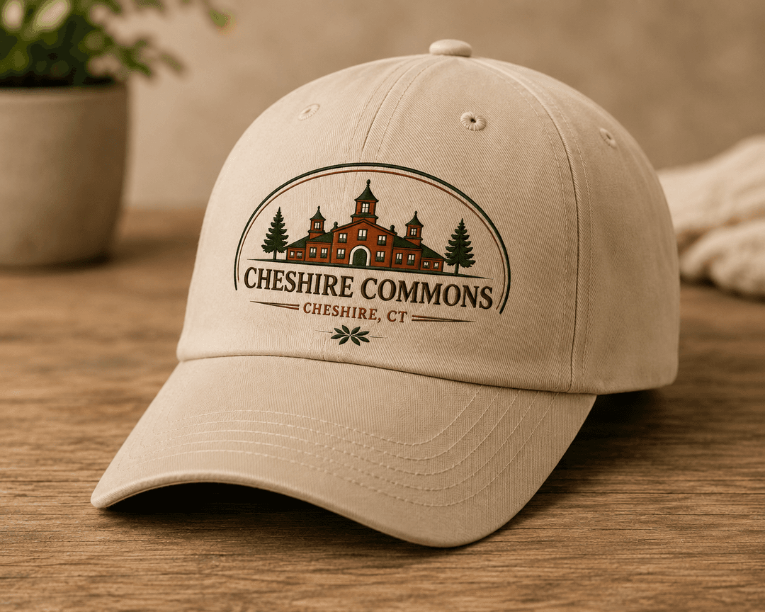 Khaki baseball cap embroidered with the Cheshire Commons crest