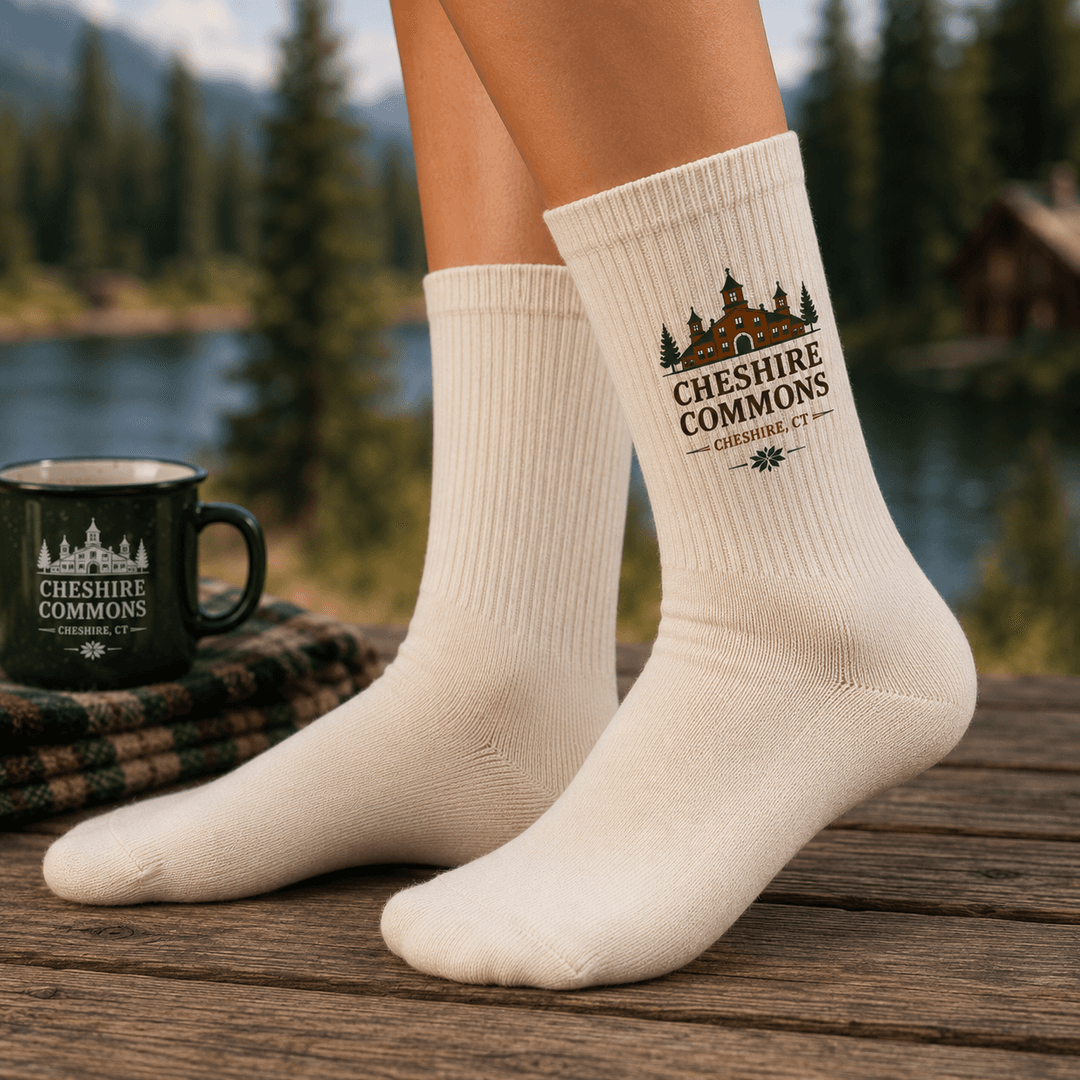Ivory crew socks printed with the Cheshire Commons crest