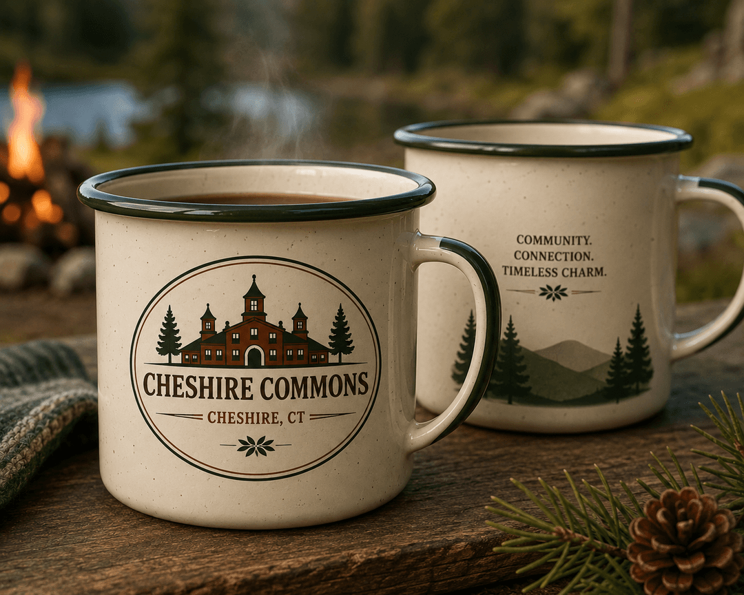Speckled enamel camp mug with a Cheshire Commons crest, by a campfire