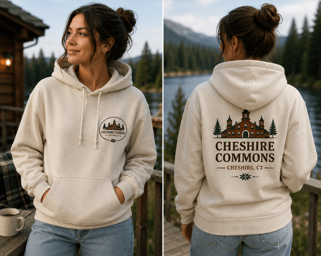 Model wearing an ivory fleece hoodie with a Cheshire Commons crest and full back print