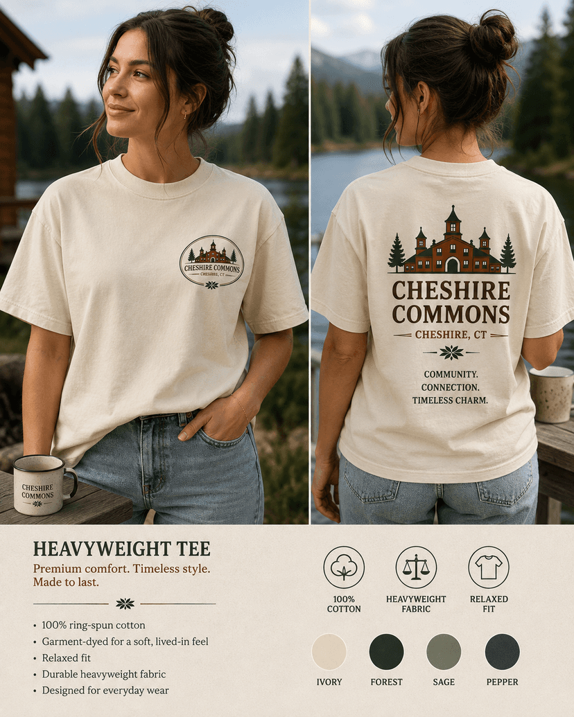 Model wearing an ivory heavyweight tee with a Cheshire Commons crest and full back print