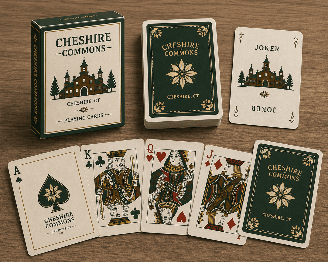 Deck of Cheshire Commons playing cards with green and gold crest design, fanned out